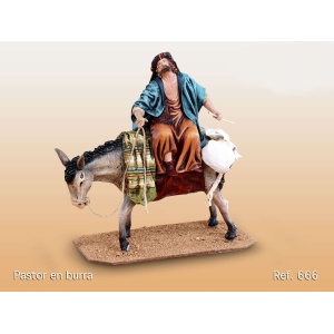 Pastor montado en burra barro lienzado