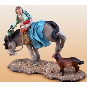 Niño montado en burra en barro lienzado