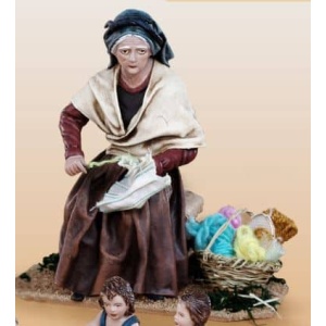 Pastora cosiendo en barro lienzado