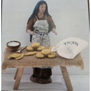 Pastora vendiendo pan en barro lienzado