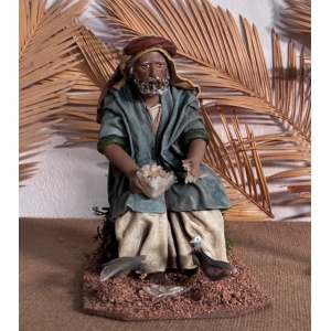 Pastor dando de comer palomas en barro lienzado